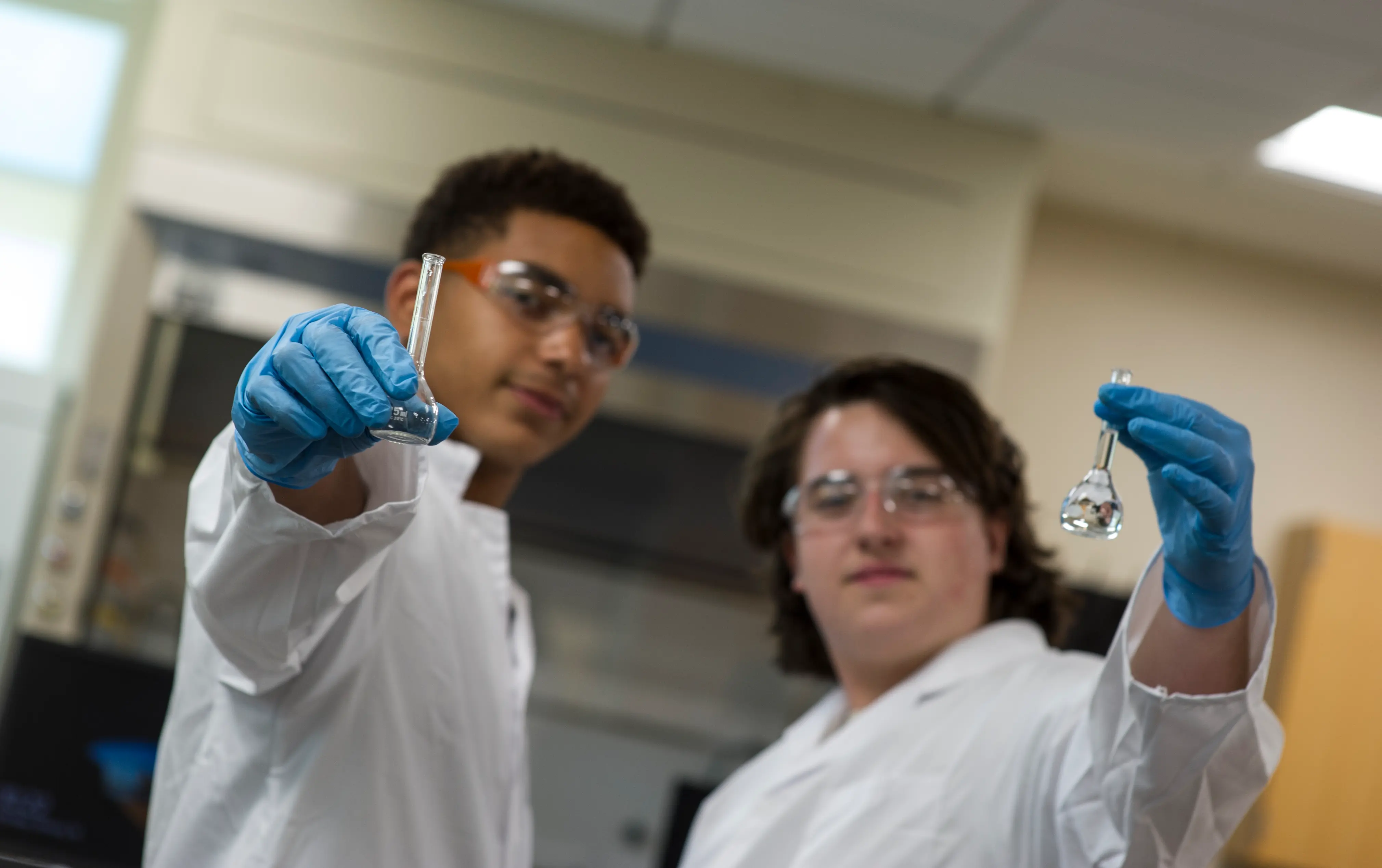 2 roberts students holding a test tube