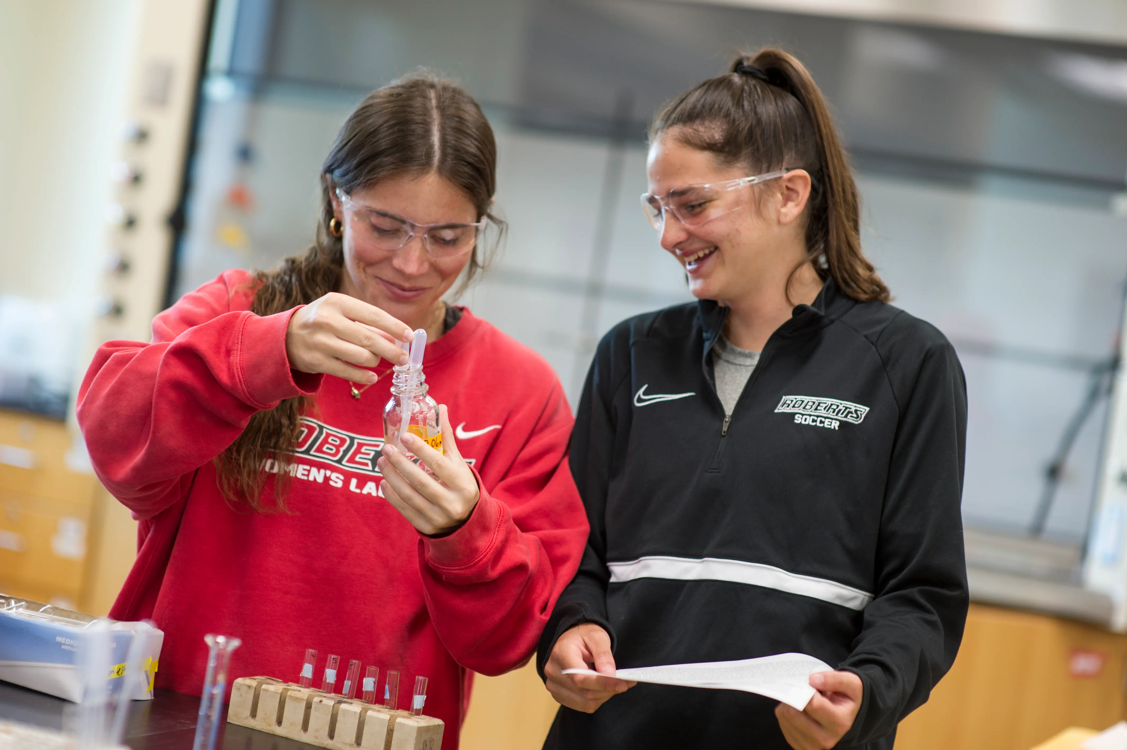 2 roberts students doing lab in roberts gear