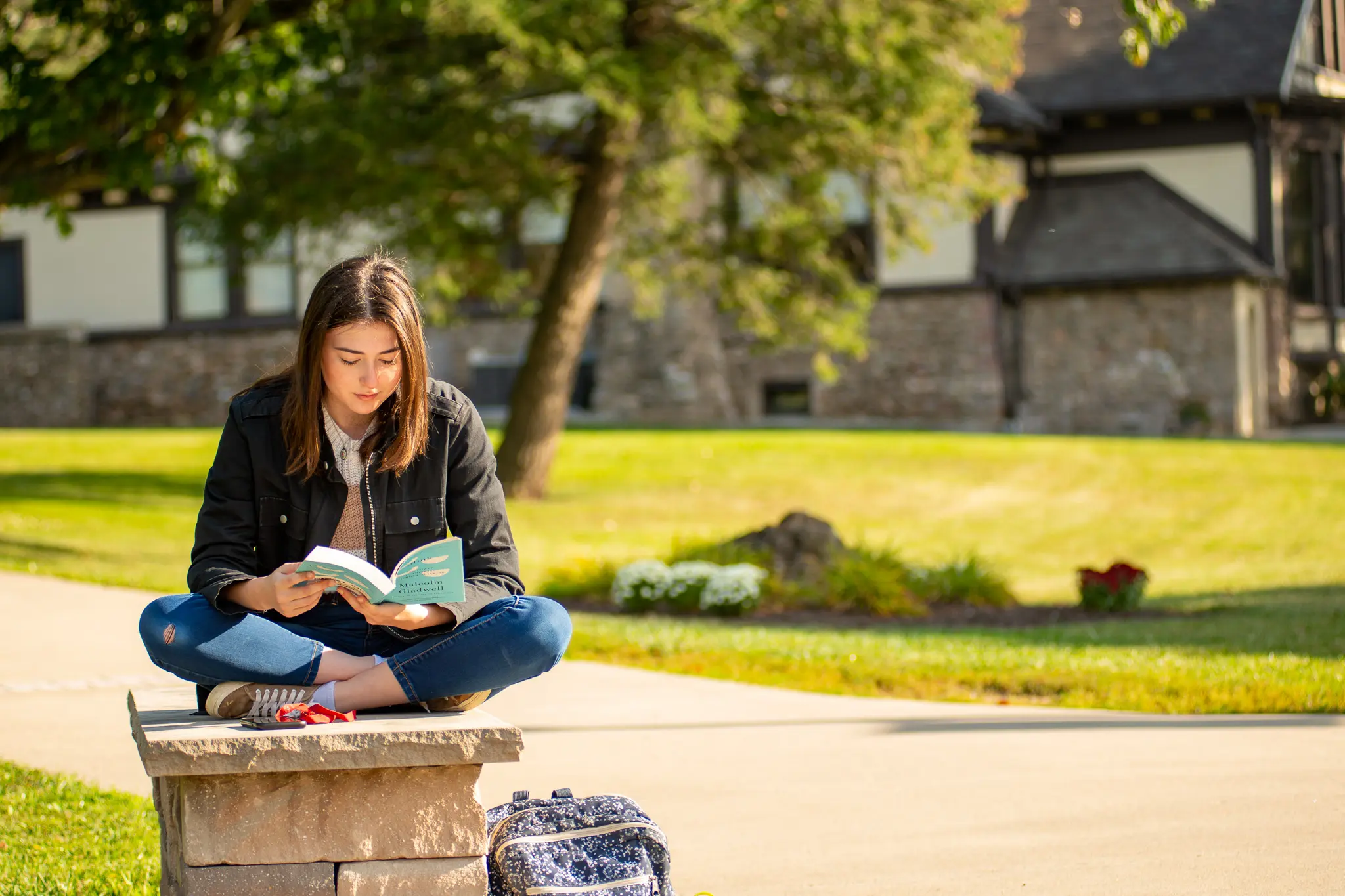 Student reads outside